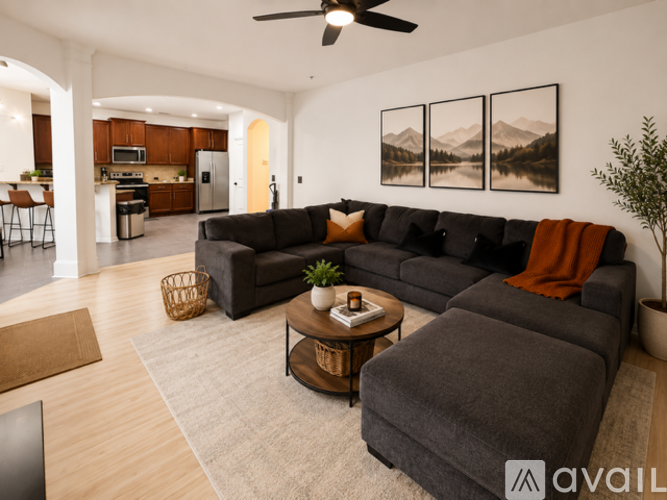 A living room with a grey couch and a coffee table.