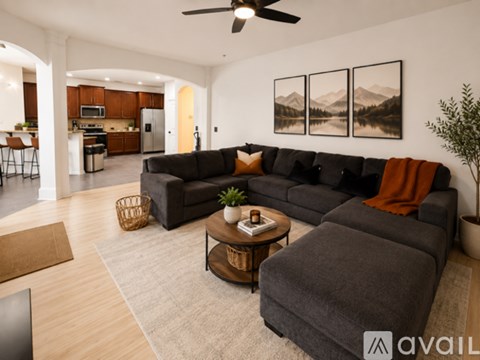 A living room with a grey couch and a coffee table.