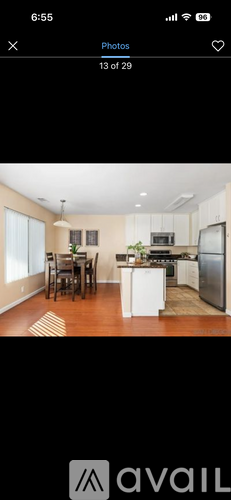 A modern kitchen with white cabinets and stainless steel appliances.