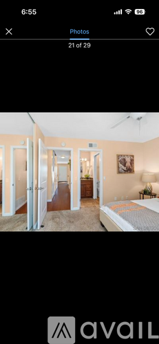 A bedroom with a bed, dresser, and mirror.