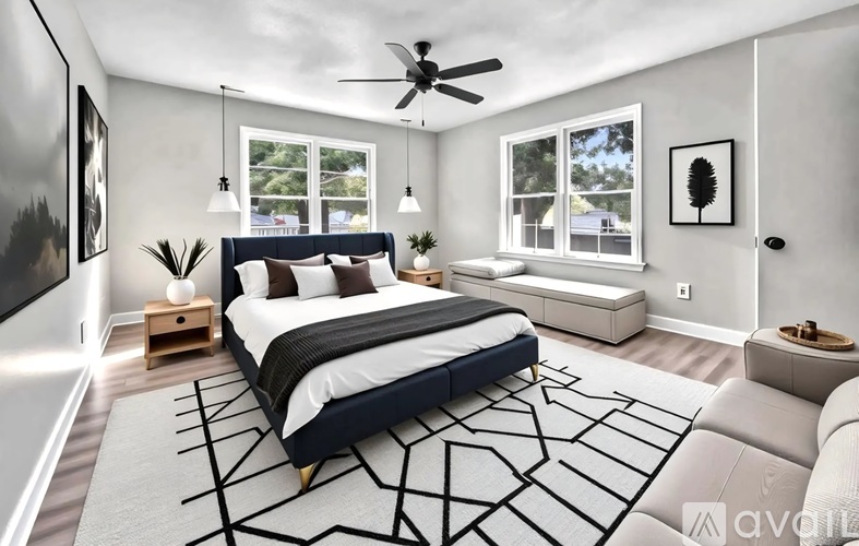 A bedroom with a large bed and a ceiling fan.