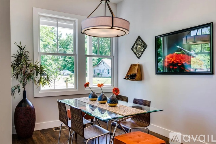 A dining room with a glass table and chairs.