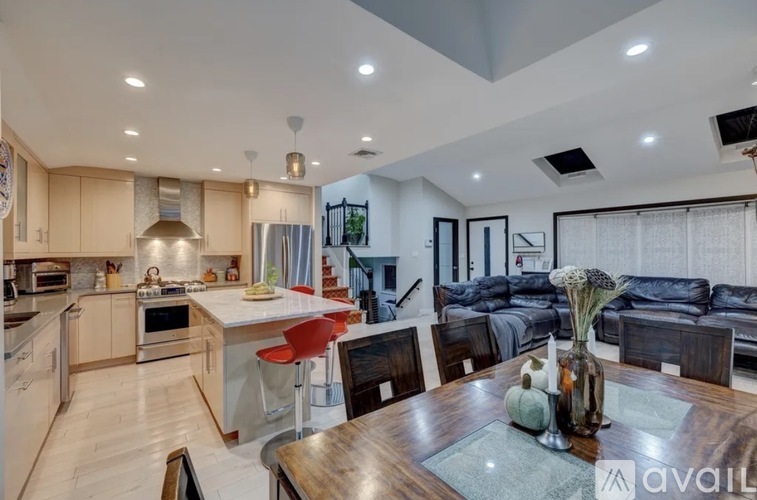 A modern kitchen with a dining table set for four.