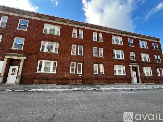 A red brick building with white doors and windows.