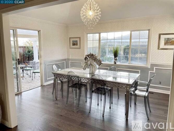 A dining room with a glass table and chairs.