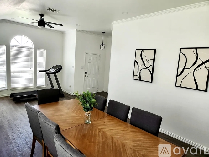 A dining room with a wooden table and chairs.