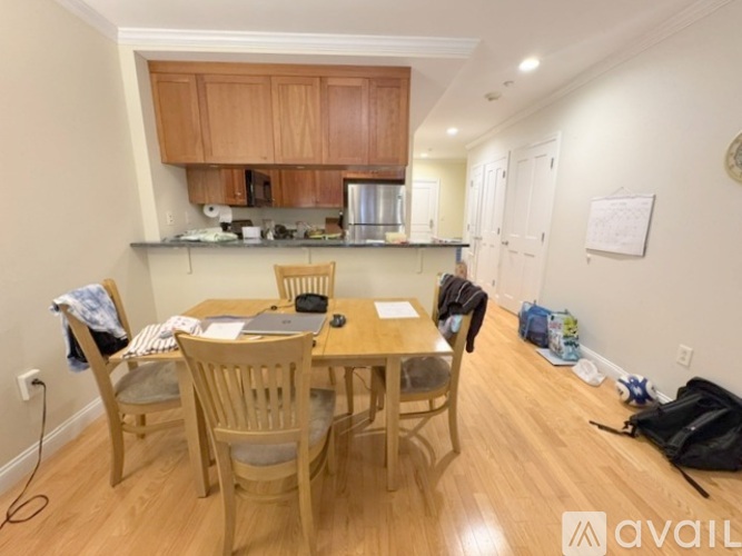 A kitchen with a table and chairs in the foreground.