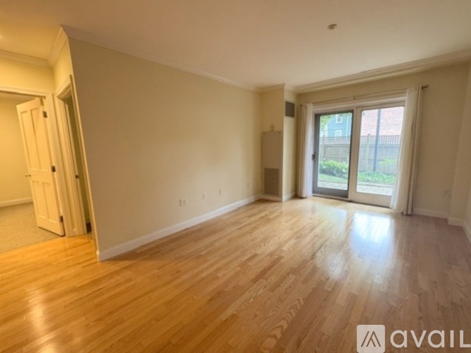 A bedroom with a bed, a window with curtains, and a wardrobe.