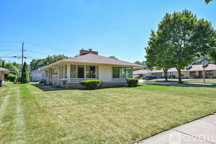 A house with a well-maintained lawn in front of it.