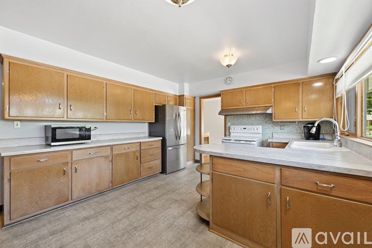A kitchen with wooden cabinets and a white countertop.