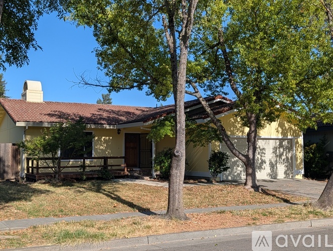 A house with a tree in front of it.