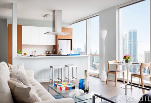 A modern living room with a white sofa and a glass coffee table.