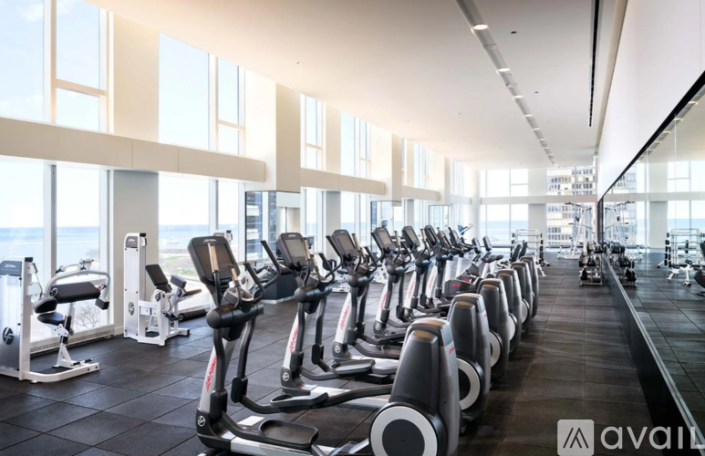 A gym with treadmills and elliptical machines.