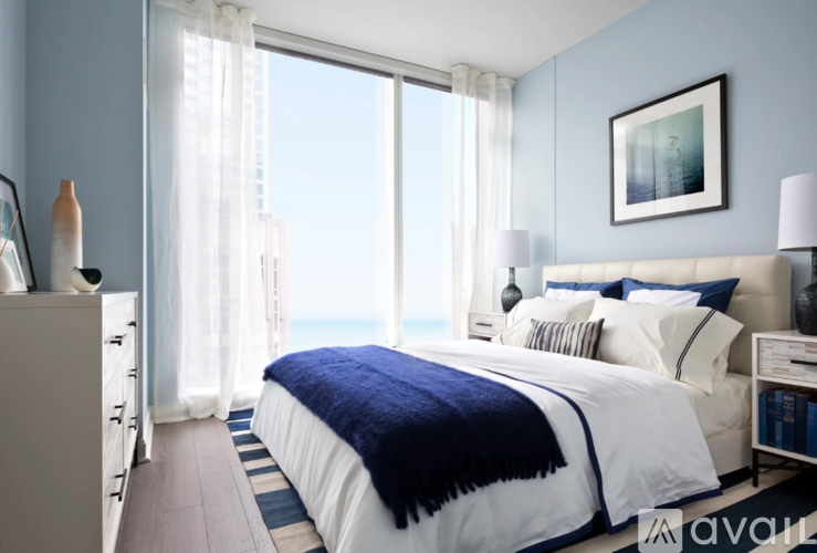A bedroom with a large bed and a view of the city.