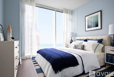 A bedroom with a large bed and a view of the city.