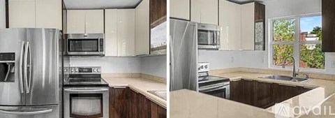A kitchen with a refrigerator, microwave, oven, and sink.