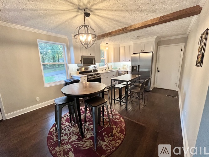 A kitchen with a table and chairs in the middle of the room.