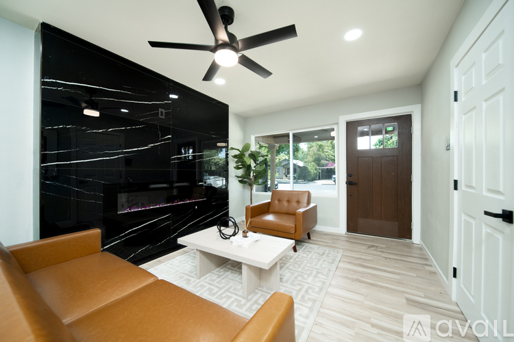 A living room with a brown leather chair and a white coffee table.