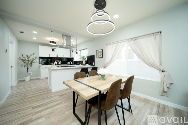 A modern kitchen with a dining table and chairs.