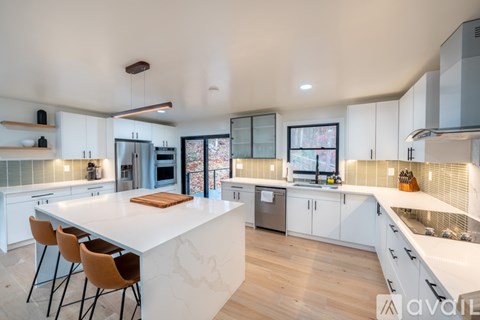 A modern kitchen with white cabinets and a large island.