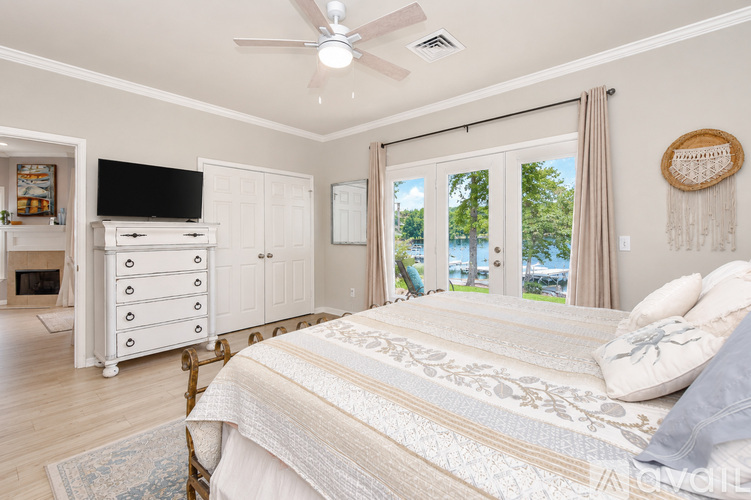 A bedroom with a large bed and a television.