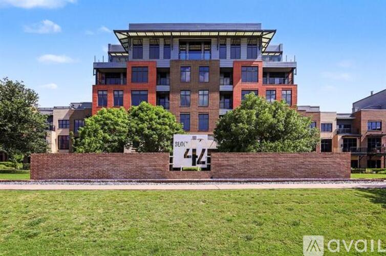 A modern building with a sign that says "PLC 474" in front of it.