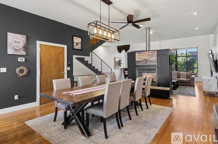 A modern dining room with a wooden table and chairs.