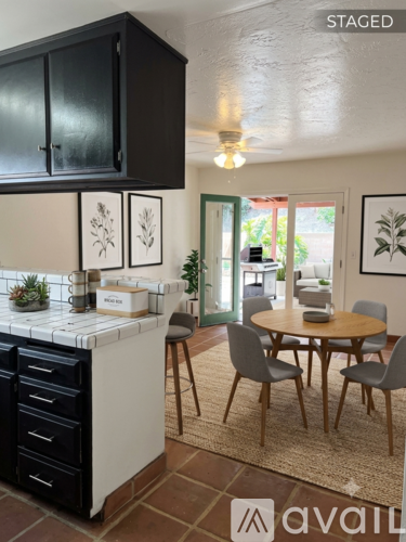 A kitchen with a table and chairs in the middle of the room.