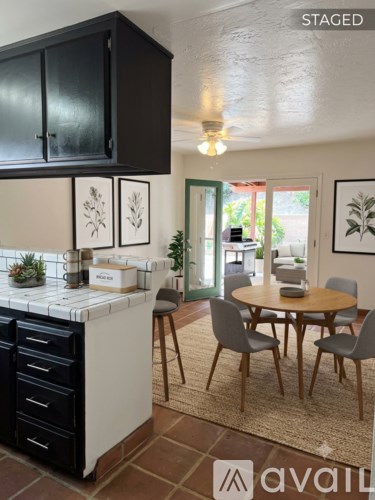 A kitchen with a table and chairs in the middle of the room.