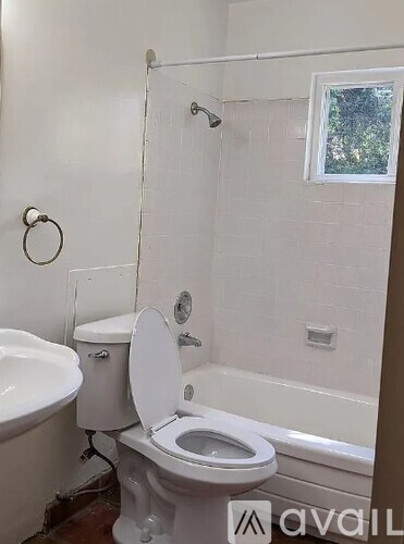 A white toilet with a white toilet seat cover is in a bathroom.