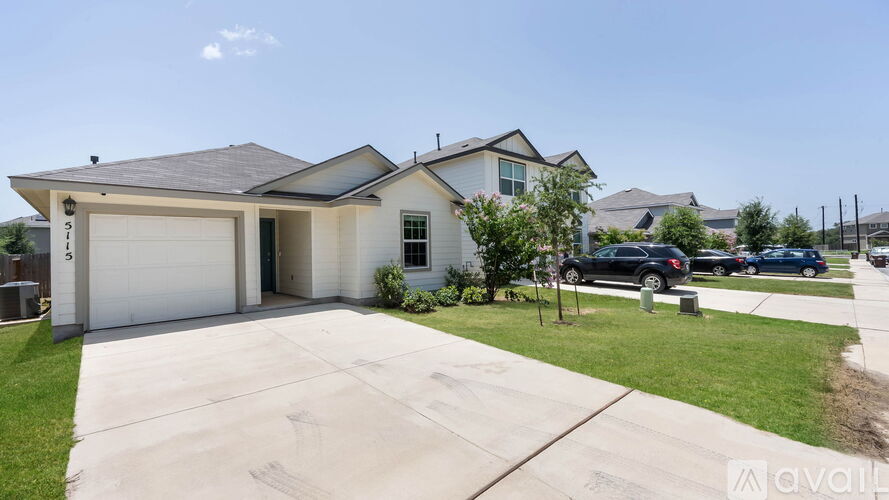 A house with a garage and a driveway is available for sale.