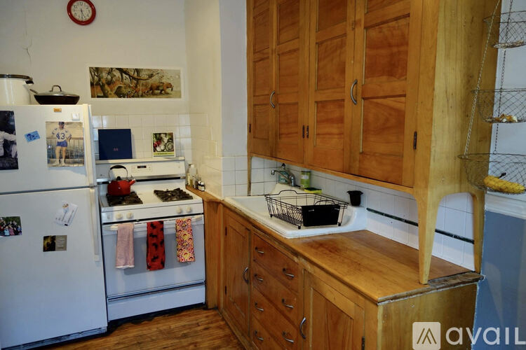 A kitchen with wooden cabinets and a white fridge.