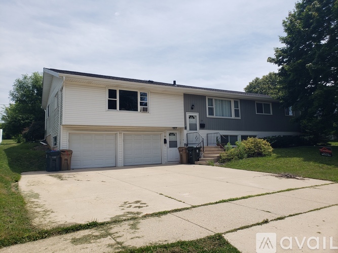 A two-story house with a garage is available for rent.