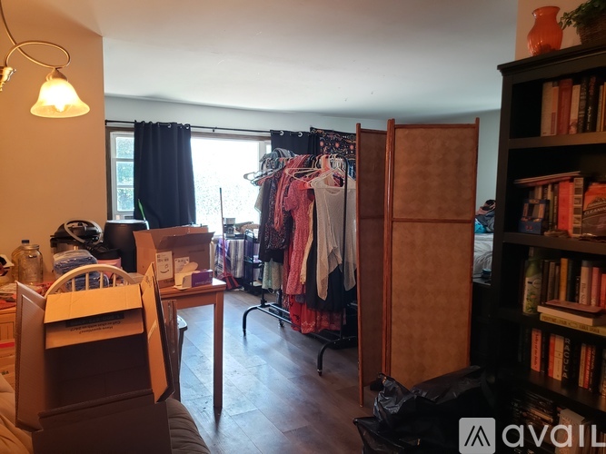 A room with a bed, a wardrobe, a desk, and a bookshelf.