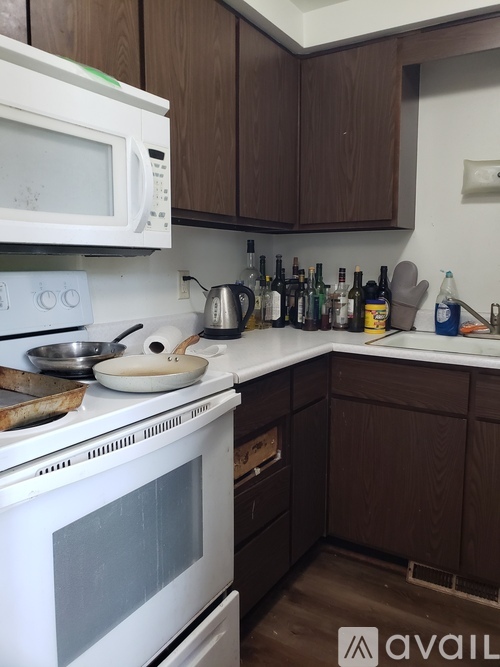 A kitchen with a white oven and brown cabinets.