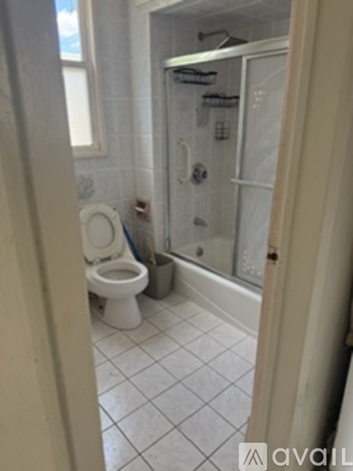 A bathroom with a toilet and a walk in shower.