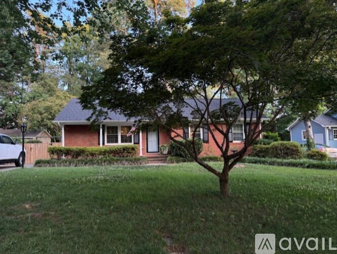 A house with a tree in front of it.