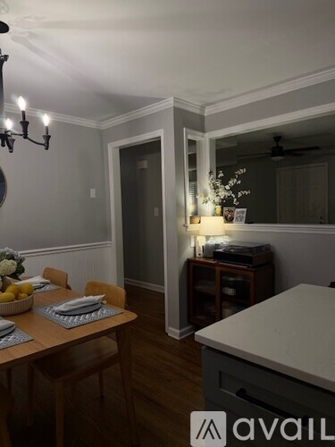 A dining room with a wooden table and chairs.