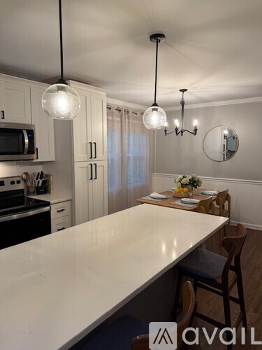 A kitchen with a dining table set for four.