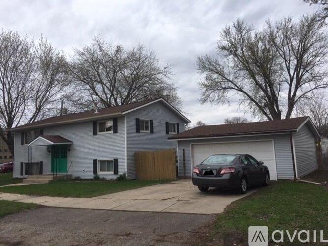A house with a car parked in front of it.