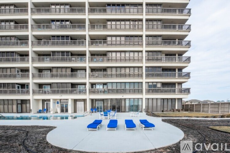 A large building with a pool in front of it.