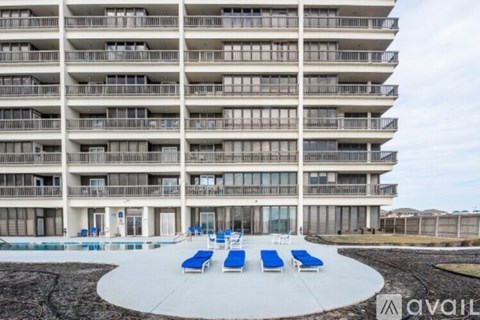 A large building with a pool in front of it.