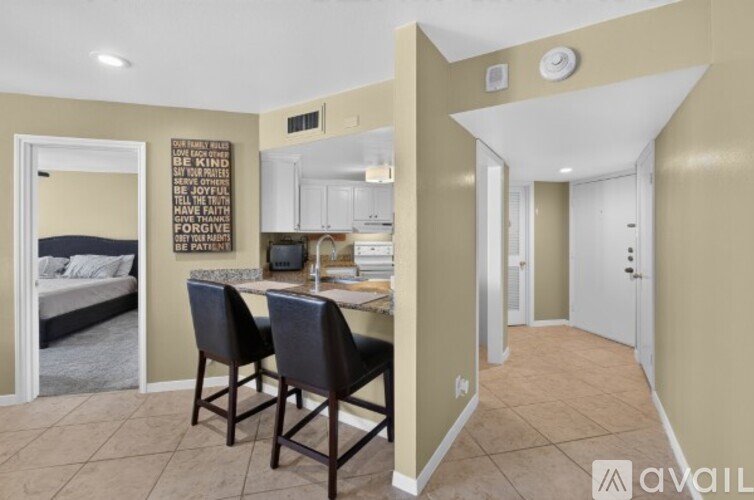 A kitchen area with a dining table and chairs.