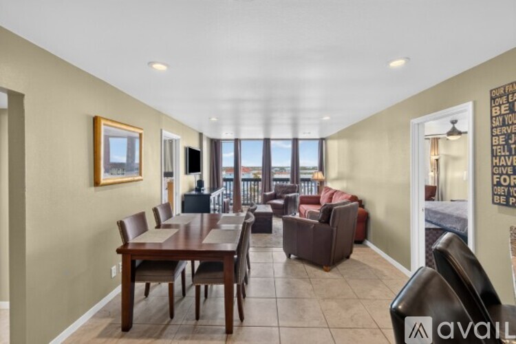 A living room with a long table and chairs.