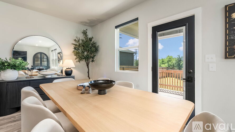 A dining room with a wooden table and chairs.