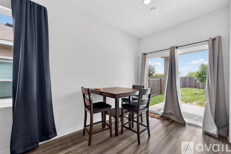 A dining room with a table and chairs is shown.