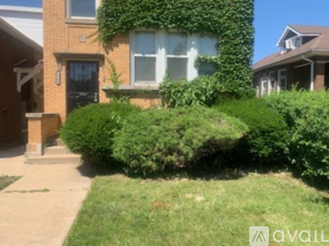 A house with a green bush in front of it.