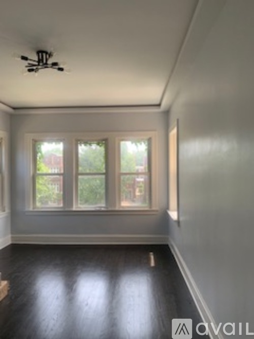 A room with a ceiling fan and a window.