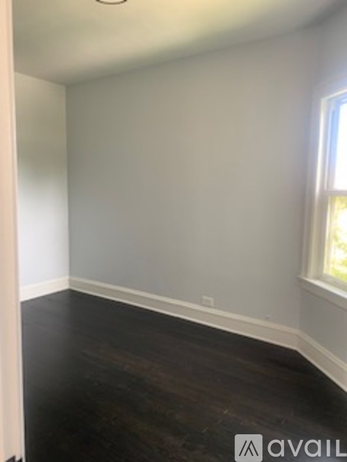 A room with wooden floors and white walls.