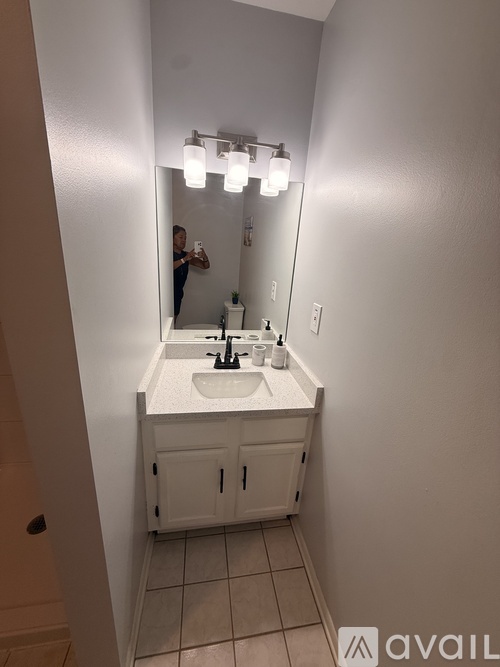 A bathroom with a sink and mirror.